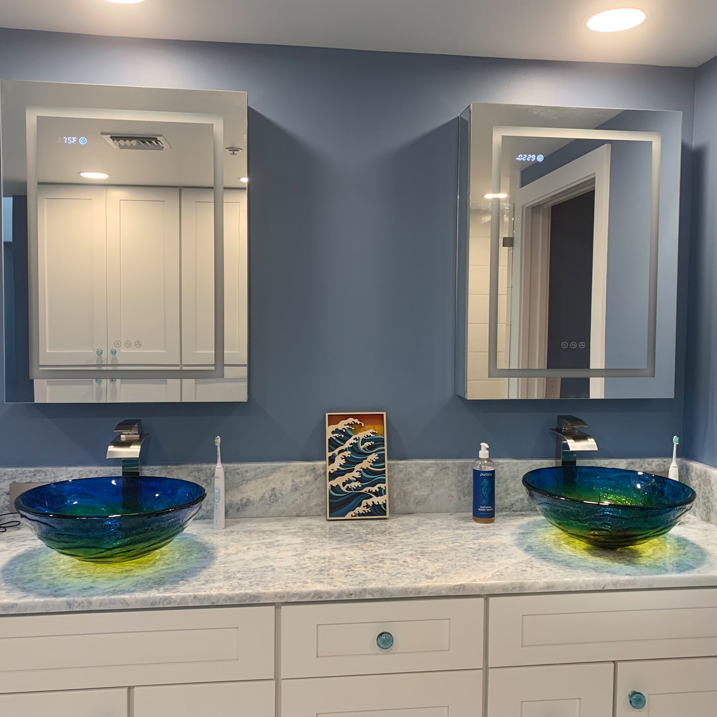 Modern blue ombre round tempered glass vessel bathroom sink by Novatto, shown with faucet in a stylish bathroom setting.