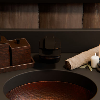 Oval copper undermount bath sink in antique finish by Novatto, traditional bathroom style with detailed craftsmanship.