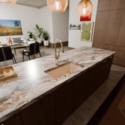 Novatto StoneCore 30-inch single bowl kitchen sink in sandstone with included accessories and faucet in the image.
