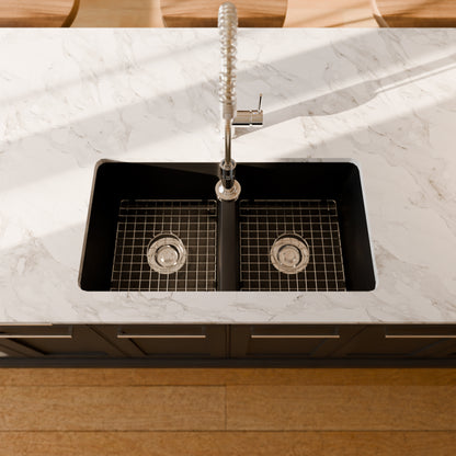 Black StoneCore double bowl kitchen sink by Novatto, showing two basins and modern design with attached faucet and accessories.
