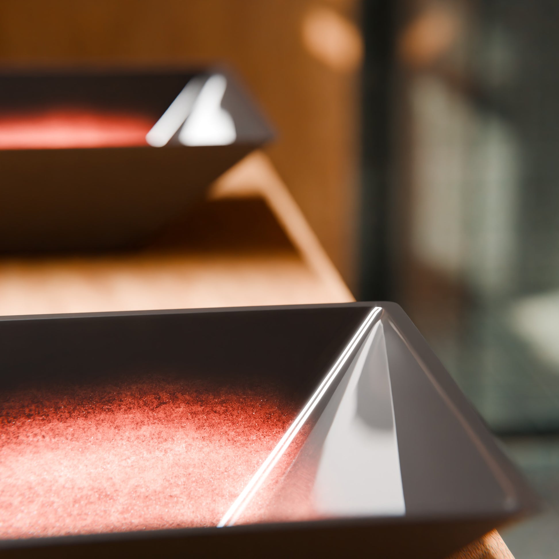 Modern copper and black square glass vessel bathroom sink by Novatto, featuring a sleek design and clear glass surface.