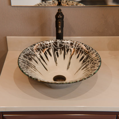 Dark modern round tempered glass vessel sink by Novatto, stylish bathroom fixture with smooth, curved design.