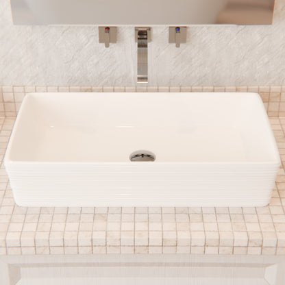 White porcelain vessel sink with rectangular shape and grooved exterior, designed by Novatto for modern bathrooms.