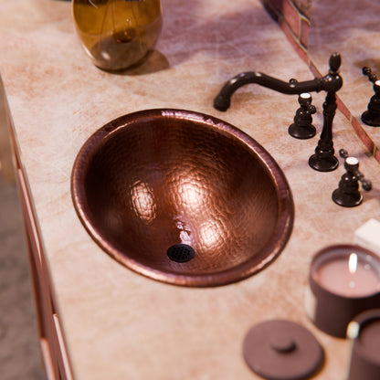 Traditional oval copper drop-in bathroom sink with rolled rim in antique finish, by Novatto.
