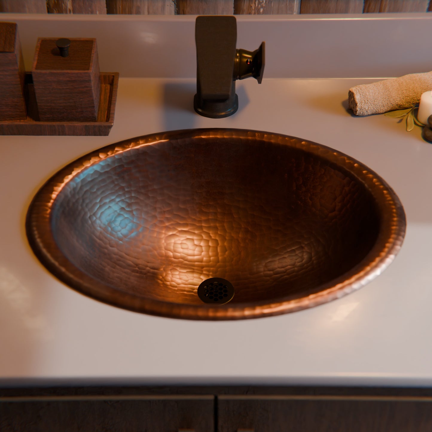 Traditional oval copper drop-in bathroom sink with rolled rim in antique finish by Novatto, showcased from a top view.
