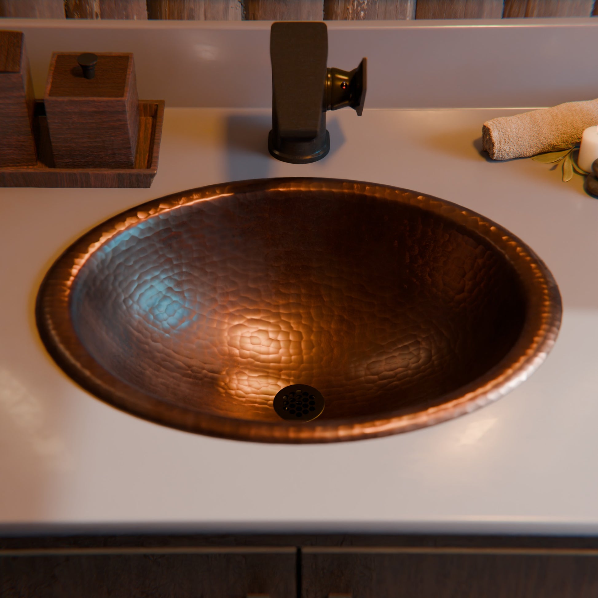Traditional oval copper drop-in bathroom sink with rolled rim in antique finish by Novatto, showcased from a top view.