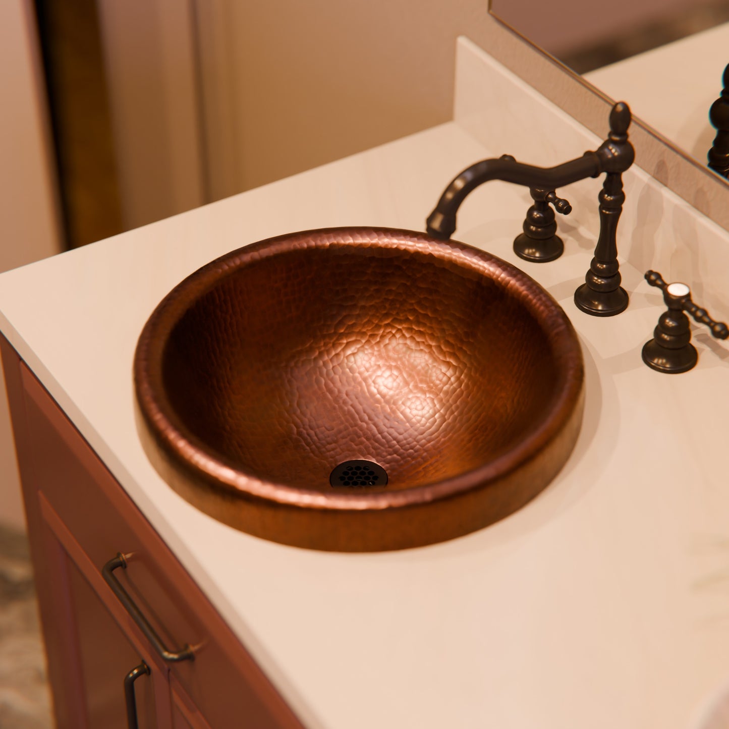 Round copper drop-in bathroom sink in antique finish by Novatto, traditional style with detailed surface texture.