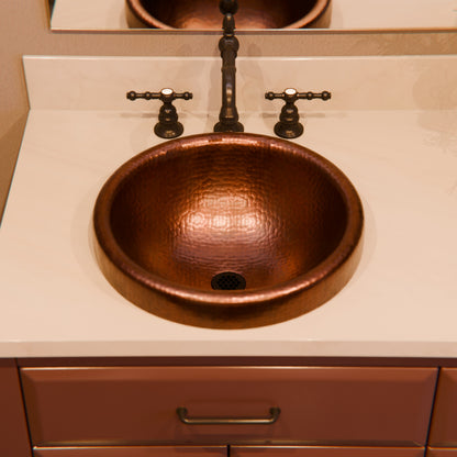 Round copper drop-in bathroom sink by Novatto in antique finish, featuring a traditional design and smooth copper surface.