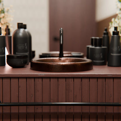 Round copper drop-in bathroom sink by Novatto with antique finish, showcasing a traditional design and smooth, shiny surface.