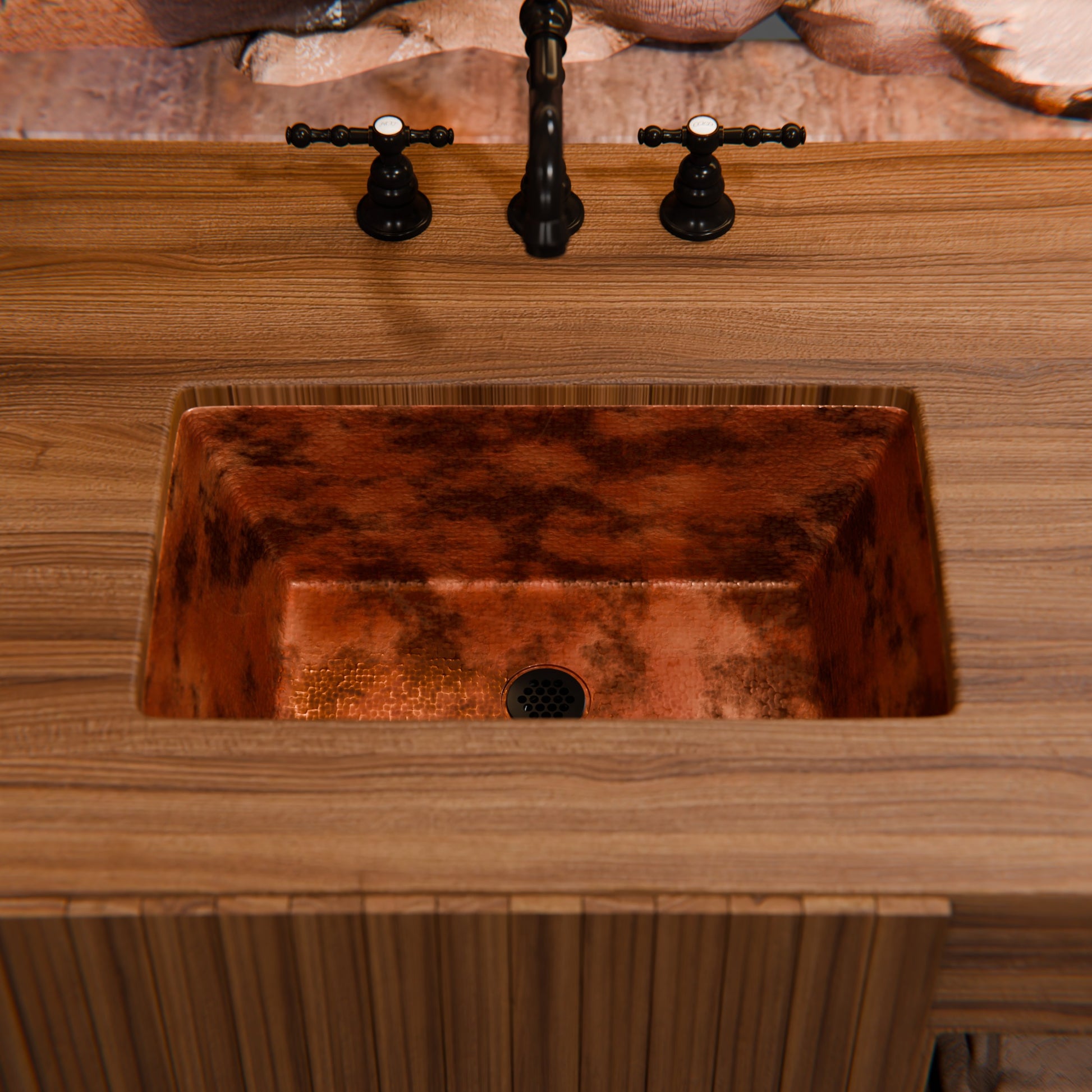 Rectangular copper traditional bathroom sink by Novatto with natural finish, shown with white porcelain faucet and oval basin.