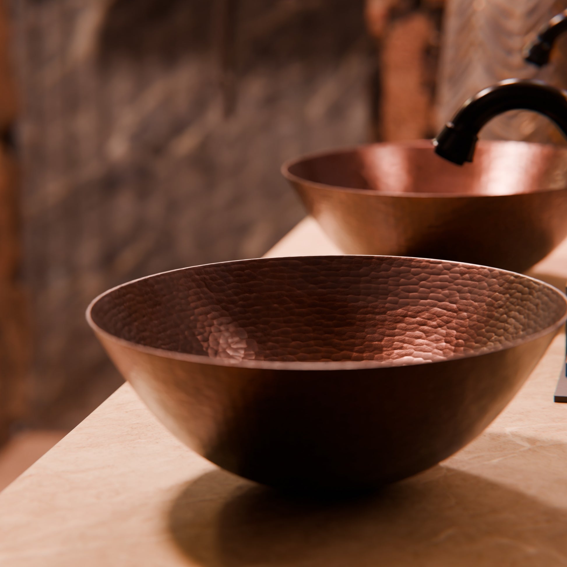 Oval hammered copper vessel bathroom sink in antique finish by Novatto, showcasing a traditional style with a textured surface.