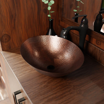 Oval hammered copper vessel bath sink by Novatto, traditional antique copper bathroom sink with a textured finish.