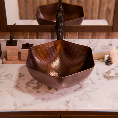 Traditional hammered copper vessel sink with scalloped edges in antique finish, designed for bathroom use by Novatto.