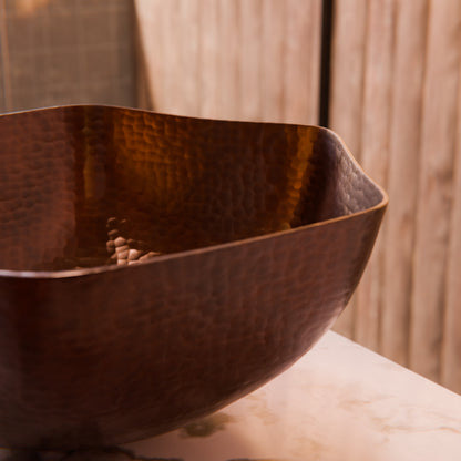 Traditional hammered copper vessel sink with scalloped edges in antique finish, by Novatto for bathroom decor.