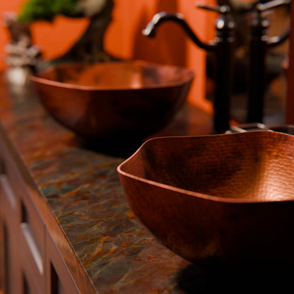 Traditional hammered copper vessel sink with scalloped edges in antique finish by Novatto, designed for bathroom use.