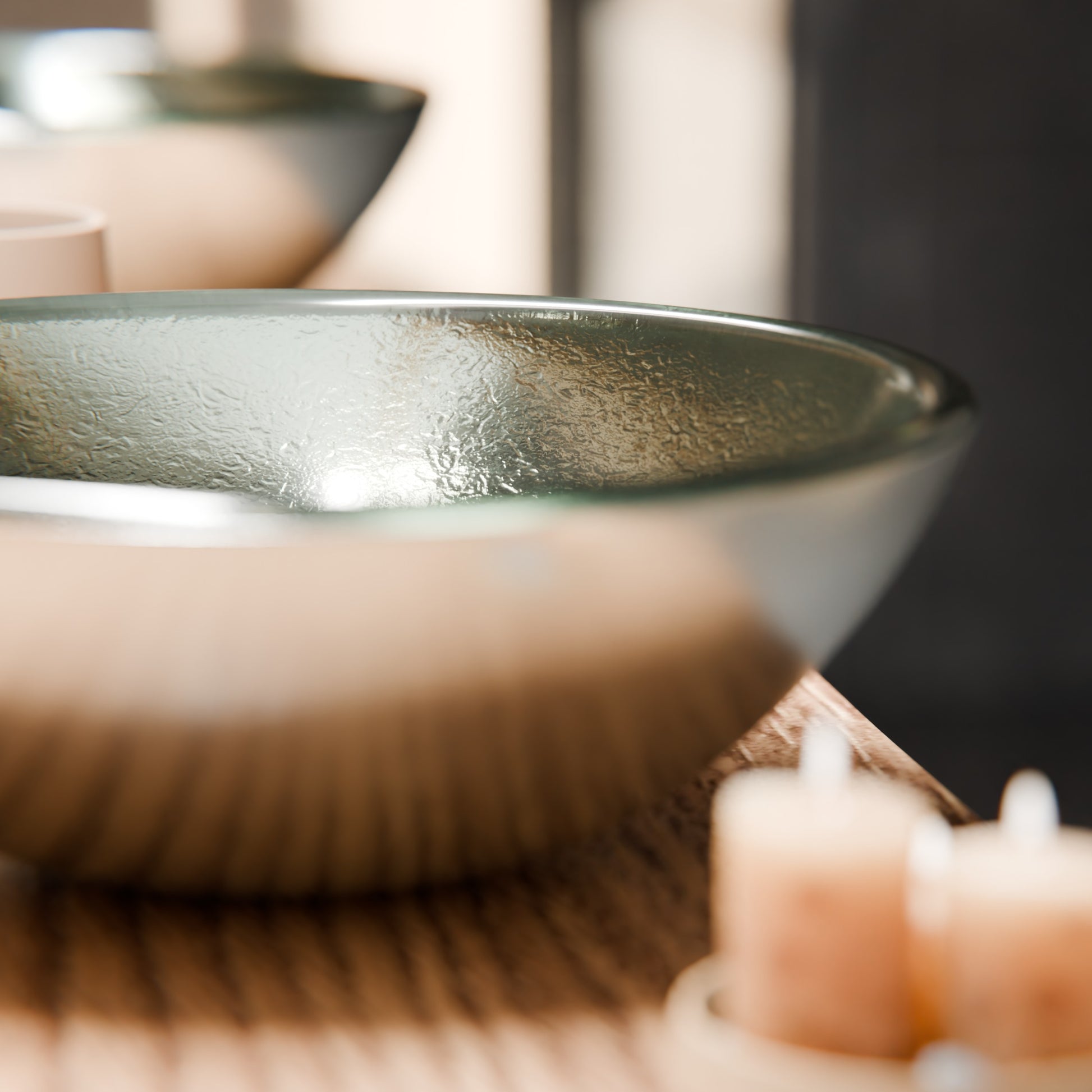 Modern silver foiled round tempered glass vessel bathroom sink by Novatto, shown on a wooden surface.