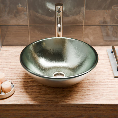 Silver foiled round tempered glass vessel bathroom sink by Novatto with wooden base, modern design for stylish bathrooms.