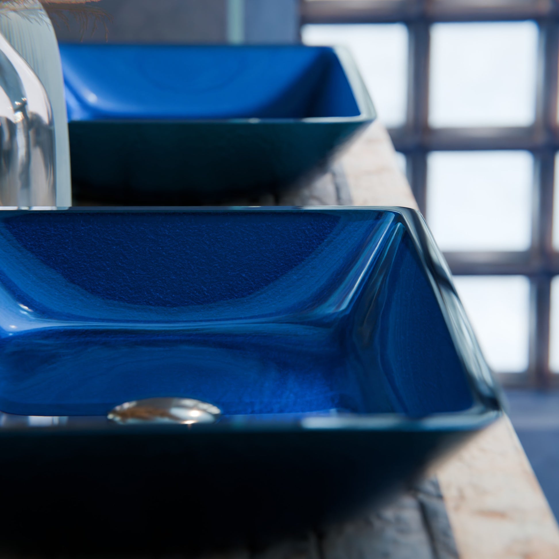 Blue hand-foiled rectangle glass vessel bathroom sink by Novatto, modern design with smooth curved edges.