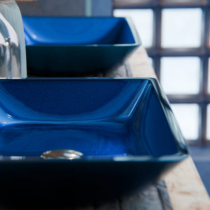 Blue hand-foiled rectangle glass vessel bathroom sink by Novatto, modern design with smooth curved edges.