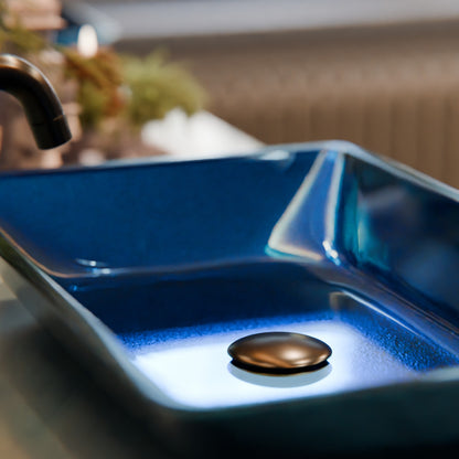 Blue hand-foiled rectangle glass vessel bathroom sink by Novatto, modern design with sleek glass surface.