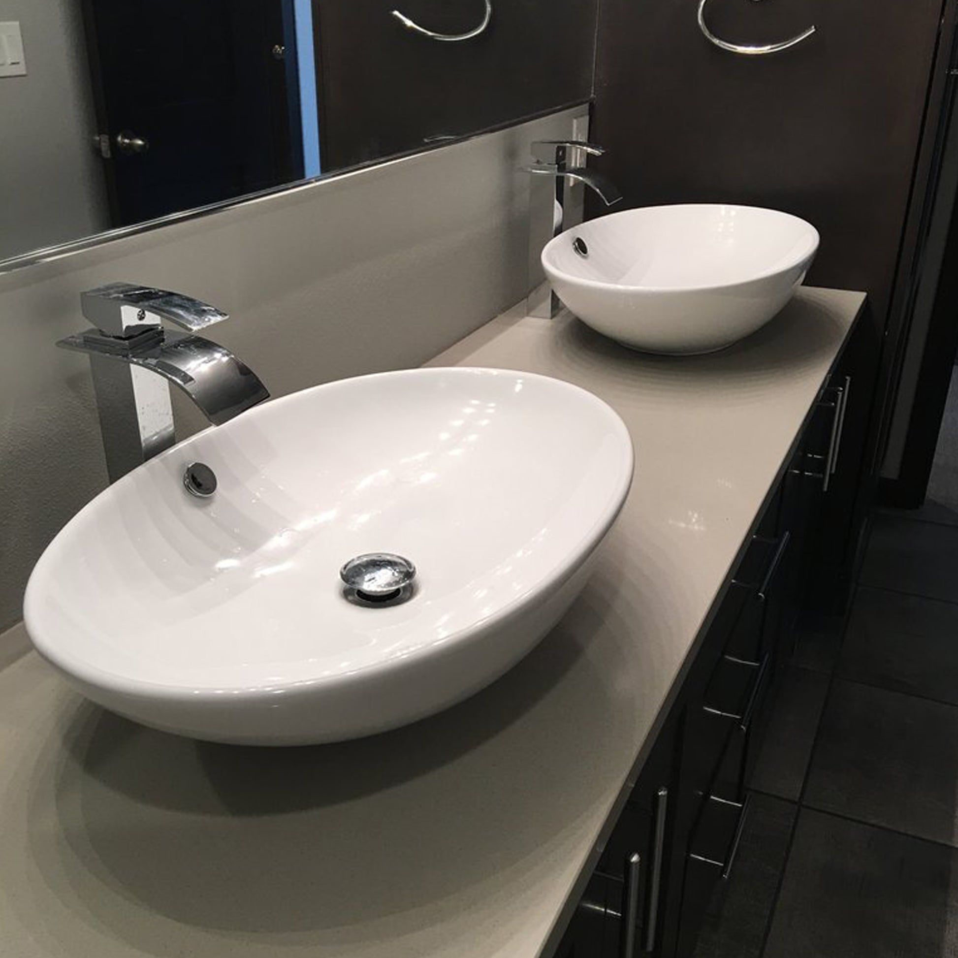 Contemporary white porcelain vessel sink with overflow, traditional bathroom style by Novatto, shown in a modern bathroom setting.
