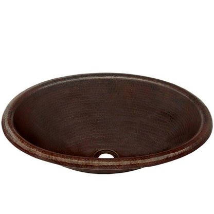 Traditional oval copper drop-in bathroom sink with rolled rim in antique finish by Novatto, shown from a three-quarter view.