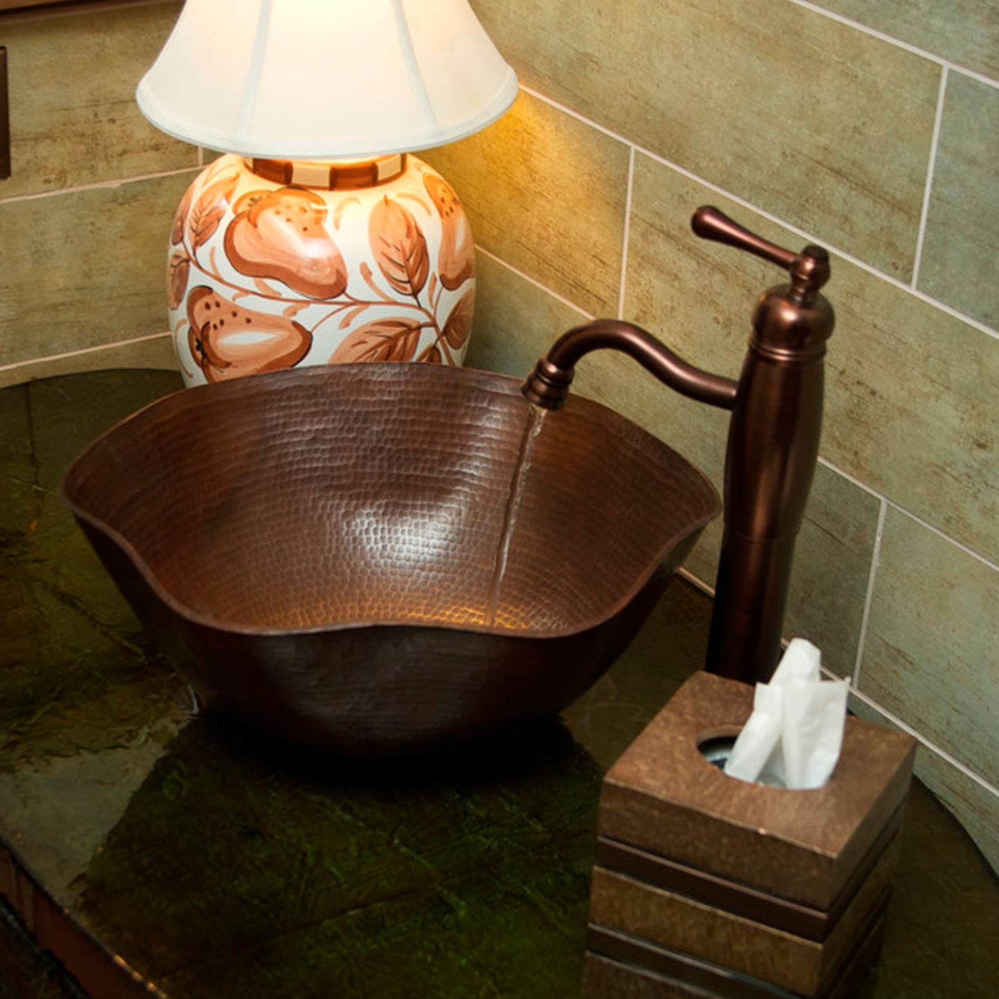 Traditional hammered copper bathroom vessel sink with scalloped edges in antique finish by Novatto, shown in a stylish bathroom setting.