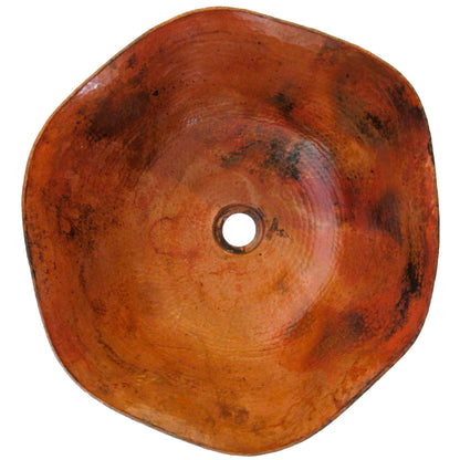 Traditional hammered copper vessel sink with scalloped edges, top view showing natural finish and textured surface.