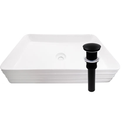 Rectangular white porcelain vessel sink with grooved exterior by Novatto, featuring clean lines and modern design.
