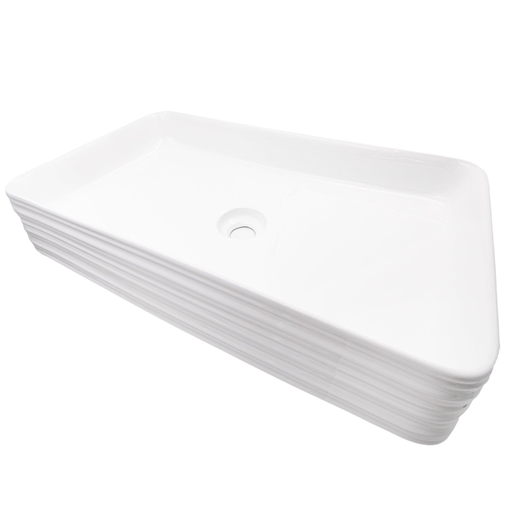 Rectangular white porcelain vessel sink with grooved exterior, designed by Novatto, shown from a side angle.