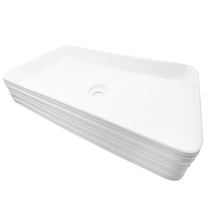 Rectangular white porcelain vessel sink with grooved exterior, designed by Novatto, shown from a side angle.