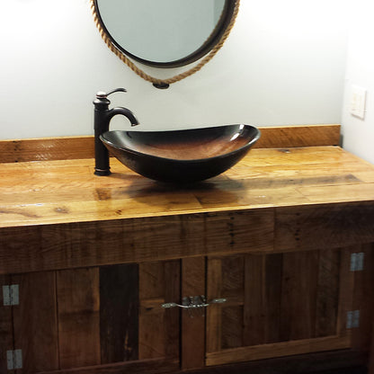 Black and copper oval glass vessel bathroom sink by Novatto, featuring a sleek transitional design with smooth glass surface.
