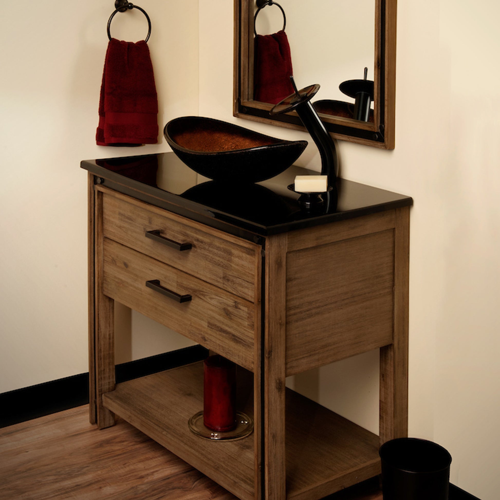 Black and copper oval glass vessel bathroom sink by Novatto, featuring a transitional design, shown with faucet and bathroom countertop.