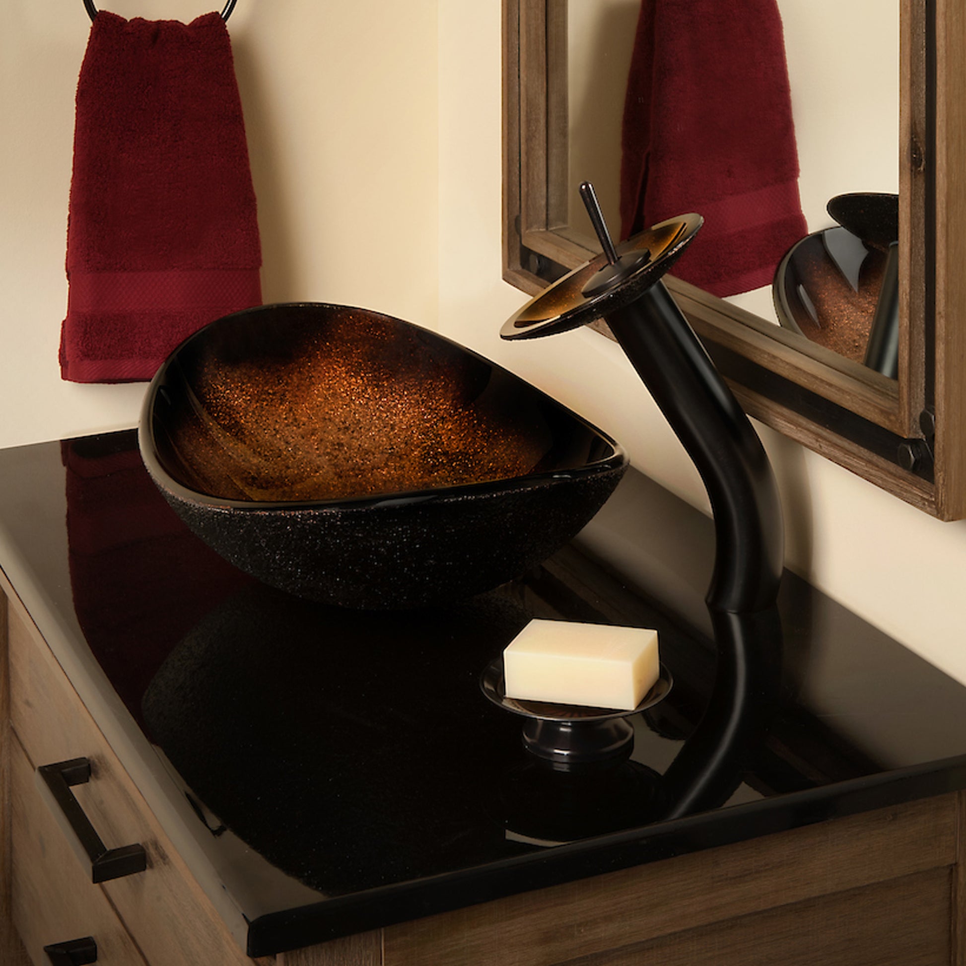 Black and copper oval glass vessel bathroom sink by Novatto, with transitional style and elegant design, shown with faucet and bathroom setup.