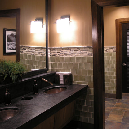 Traditional oval copper undermount bathroom sink by Novatto, antique finish, shown installed in a bathroom setting.