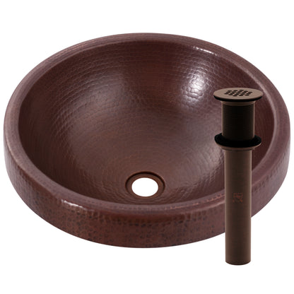 Traditional round copper drop-in bathroom sink by Novatto with antique finish, side view showing drain and strainer.