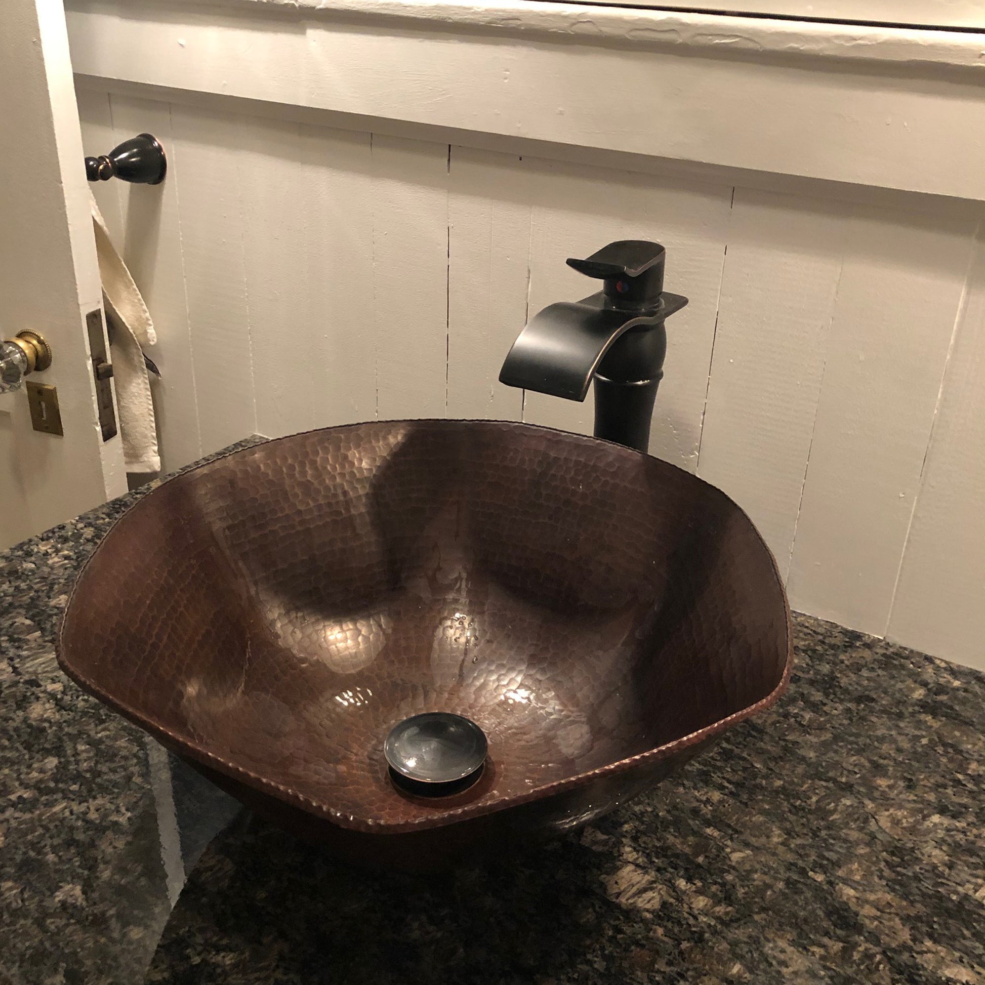 Traditional hammered copper vessel sink with scalloped edges in antique finish by Novatto, ideal for bathroom decor.