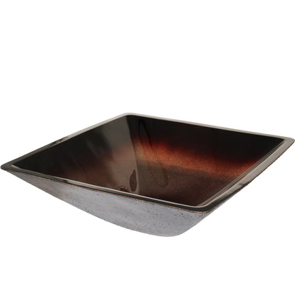 Modern copper and black square glass vessel bathroom sink by Novatto, shown from a three-quarter view.