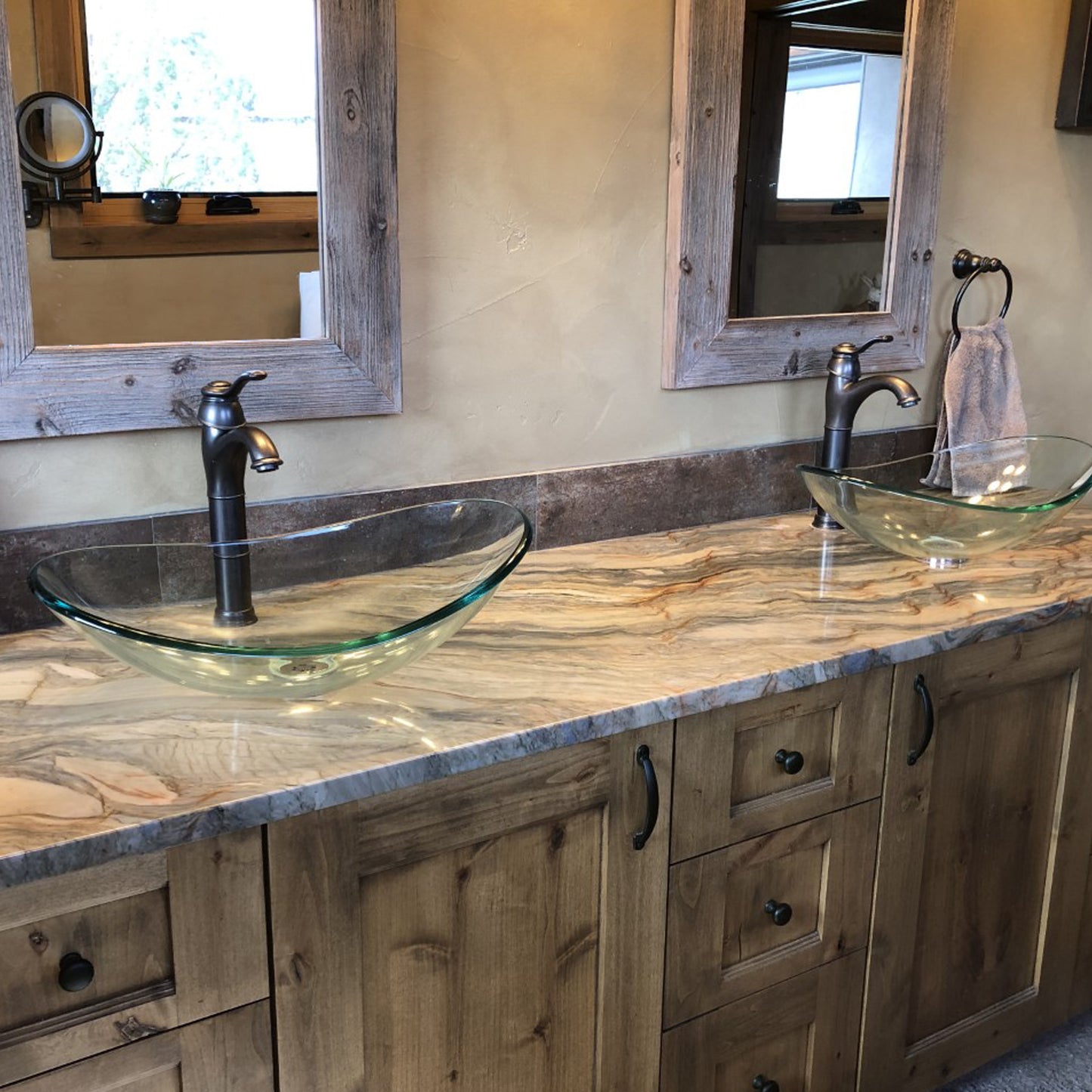 Modern clear oval tempered glass vessel bathroom sink by Novatto, shown in a stylish bathroom setting.