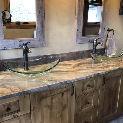 Modern clear oval tempered glass vessel bathroom sink by Novatto, shown in a stylish bathroom setting.